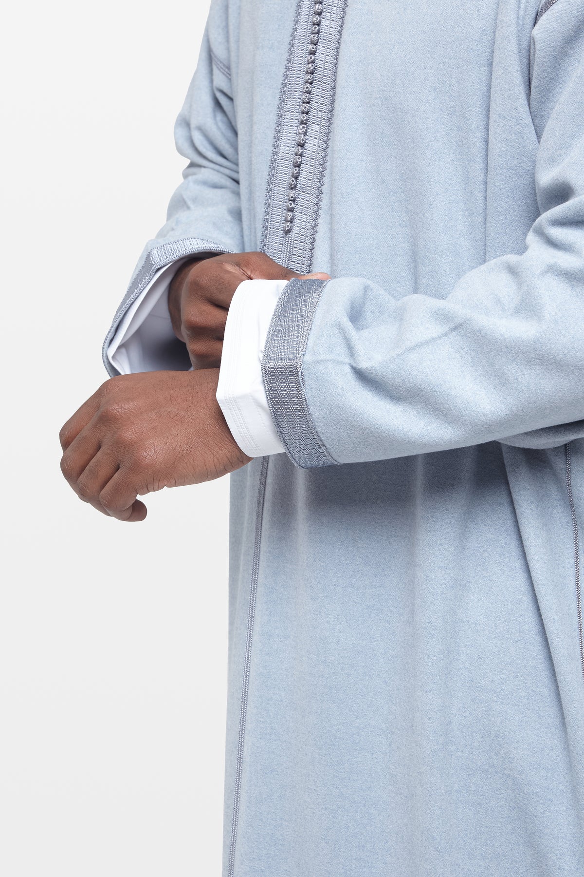 Cuff and embroidered trim on a light blue hooded Moroccan thobe